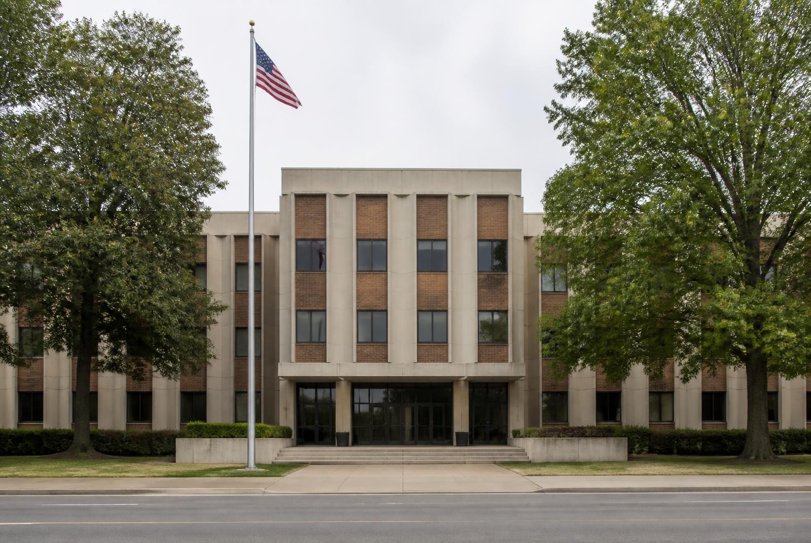 Straight-on view of a mid-century public administrative building of brick and precast concrete
